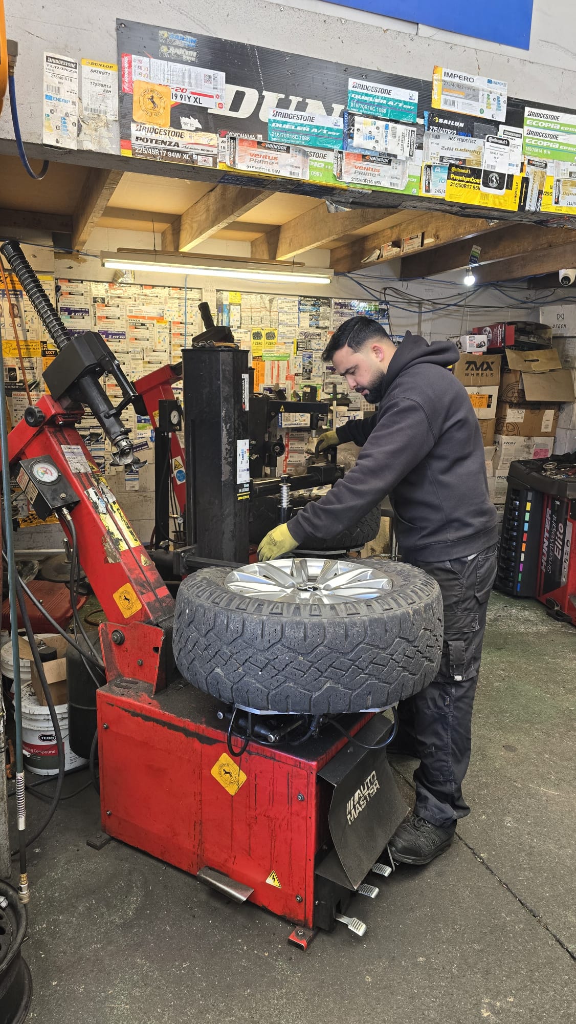 Technician fitting a tyre at Auckland Tyres, Onehunga