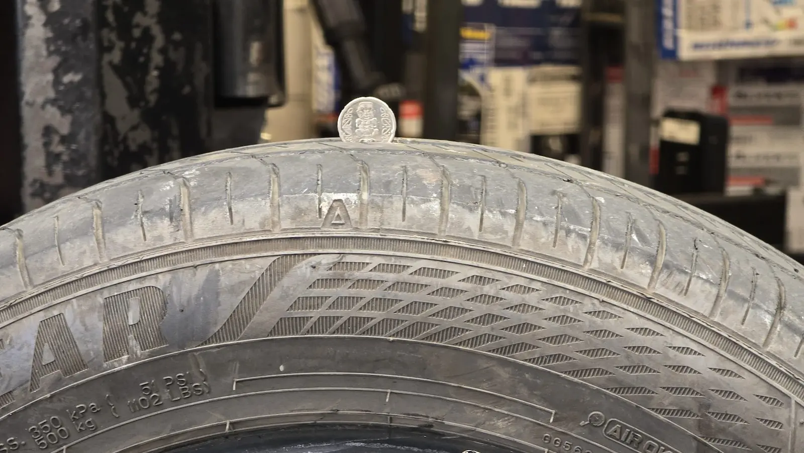 Checking tyre tread wear at Auckland Tyres, Onehunga